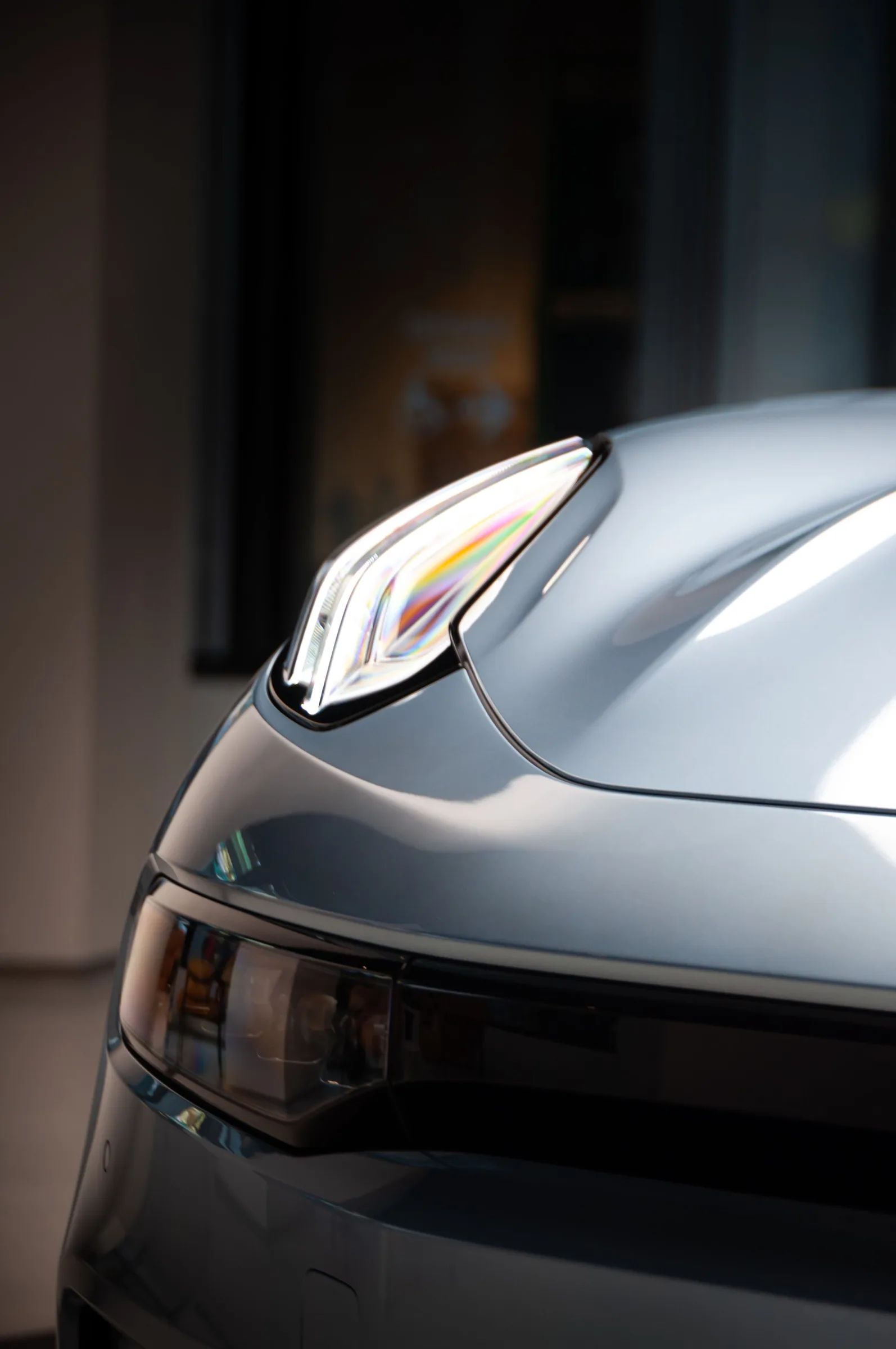 Close-up of a clear headlight on a silver car